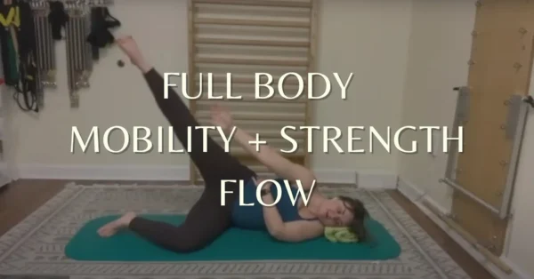 This image shows Allie Myszka, a Pilates instructor with a spinal fusion. This image describes a mat Pilates class for spinal fusion and neutral spine needs.